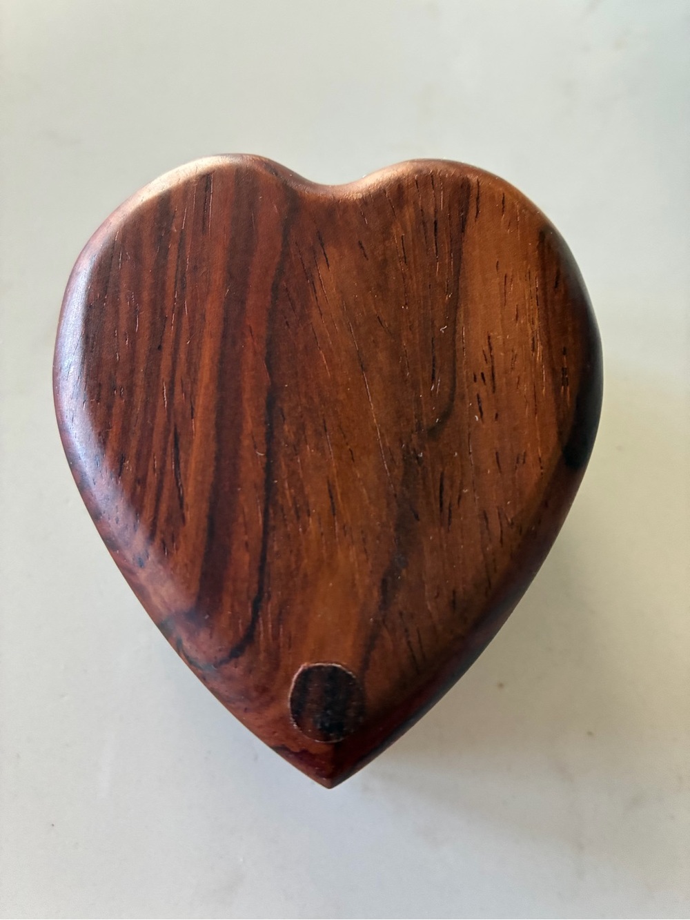Vintage  heart-shaped wooden trinket box featuring a swivel slide lid.